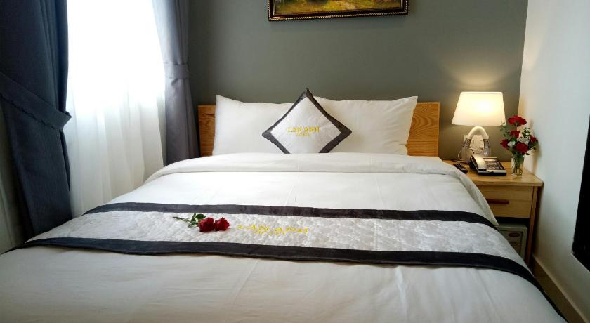 a neatly made bed in a hotel room, Lan Anh Hotel in Dalat