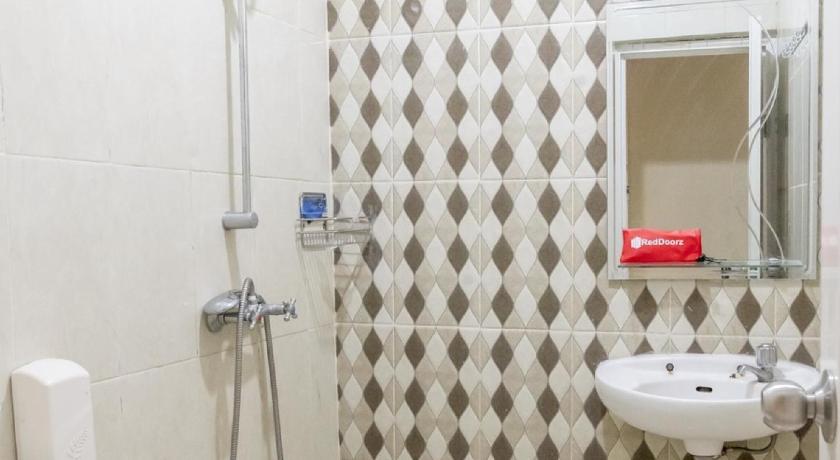 a bathroom with a toilet, sink, and shower, RedDoorz Plus near Tambun Station in Bekasi