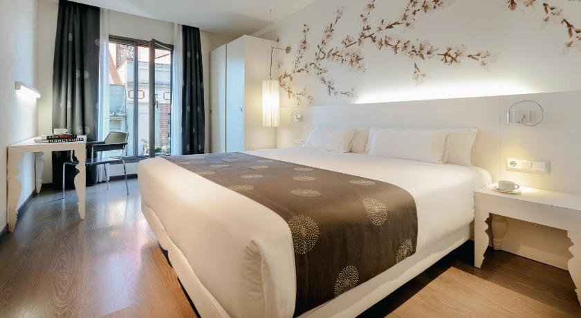 a hotel room with a large bed and a large window, RamblasHotel powered by Vincci in Barcelona
