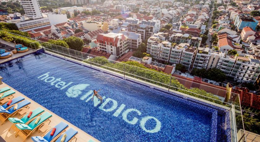 a large swimming pool filled with lots of colorful umbrellas, Hotel Indigo Singapore Katong (SG Clean Certified) in Singapore
