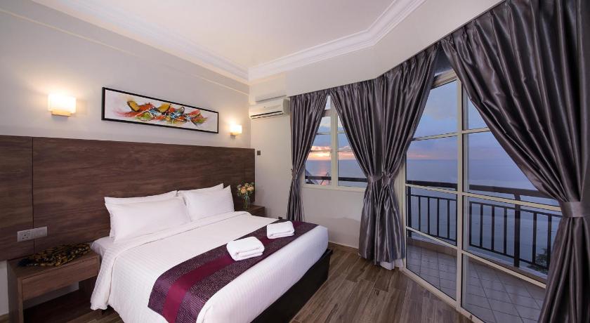 a bedroom with a large bed and a large window, Ancasa Residences - Port Dickson by Ancasa Hotels & Resorts in Port Dickson