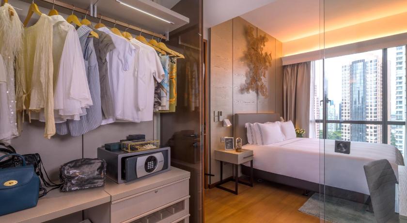 a bedroom with a bed and a dresser, Fraser Residence Orchard, Singapore (SG Clean Certified) in Singapore