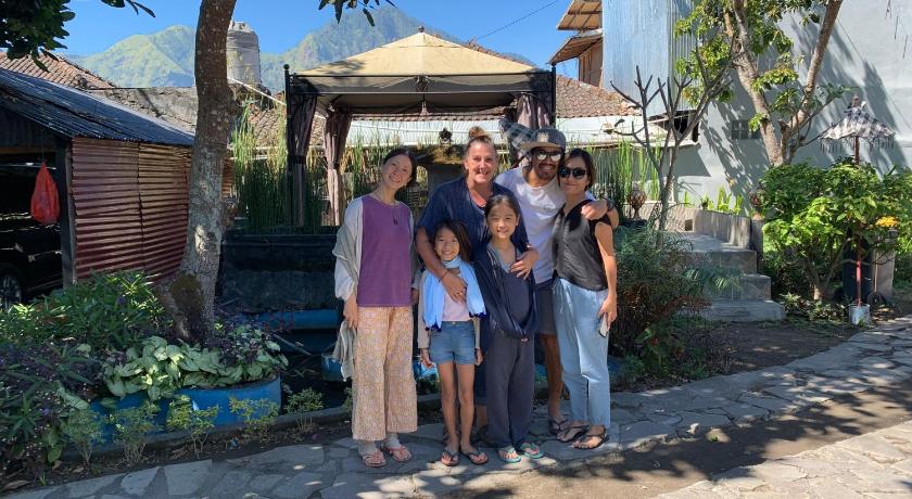 a family posing for a picture in front of a house, Batur Sunrise Guesthouse in Bali