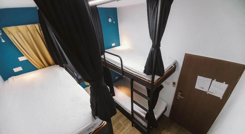 a bedroom with a bed and a desk, Central Woods Hostel in Yilan