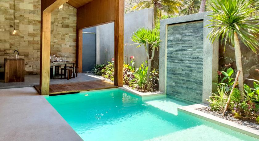 a swimming pool with a pool table in front of it, Batatu Villa in Lombok