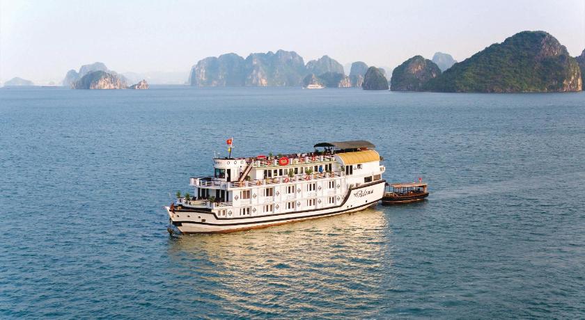 a large white boat floating on top of a body of water, Halong Paloma Cruise in Hạ Long