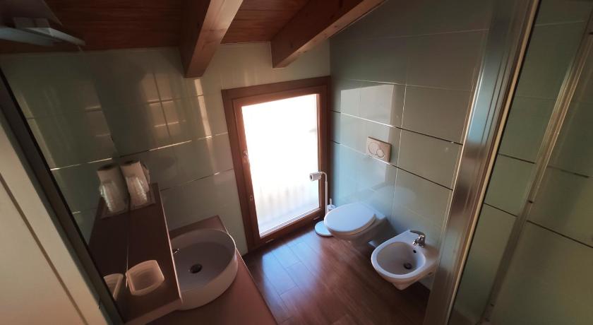 a bathroom with a toilet and a sink, Azzano Holidays B&B in Tremezzo