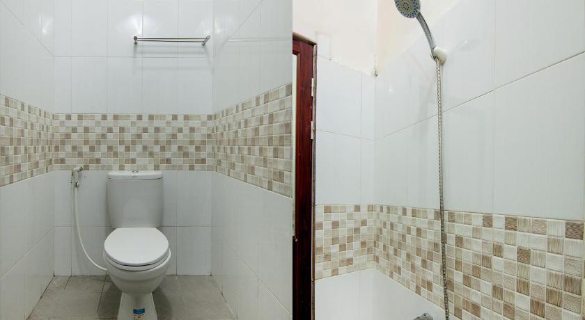 a bathroom with a toilet and a shower stall, SPOT ON 2220 Pink's Guest House in Tarutung
