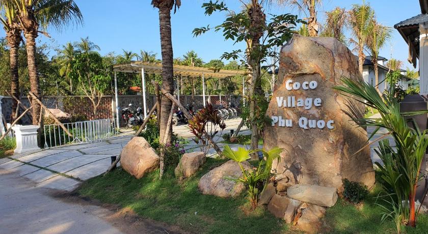 a palm tree in the middle of a grassy area, Coco Village Phu Quoc Resort & Spa in Phu Quoc Island