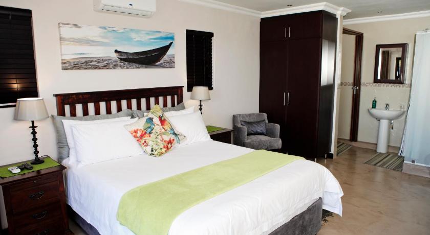 a bedroom with a bed and a dresser, Aloes No.21 in Durban