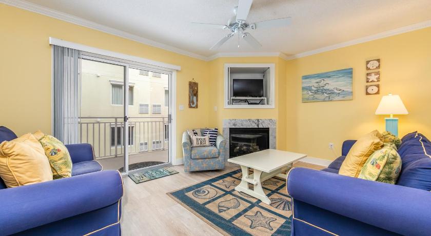 a living room filled with furniture and a fire place, Sunset Bay 309 in Ocean City (MD)