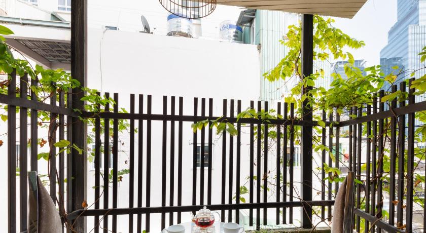 a patio area with a table and chairs, A&Em Phan Boi Chau Hotel in Ho Chi Minh City