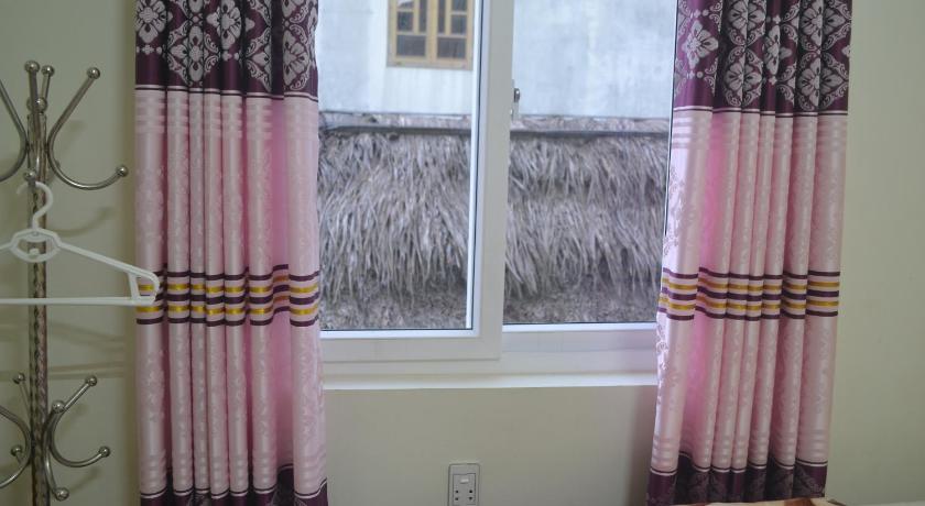 a window that has some curtains on it, Phong Nha Homestay in Đồng Hới (Quảng Bình)