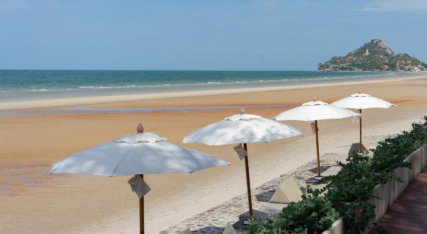 two beach umbrellas on a beach near the ocean, Loligo Resort Hua Hin (SHA Plus+) in Hua Hin / Cha-am
