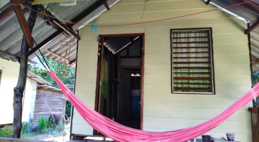 a house with a red and white umbrella hanging from the ceiling, Yak Bungalow in Koh Chang
