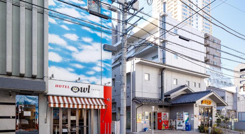 a large building with a sign on the side of it, HOTEL OWL in Tokyo