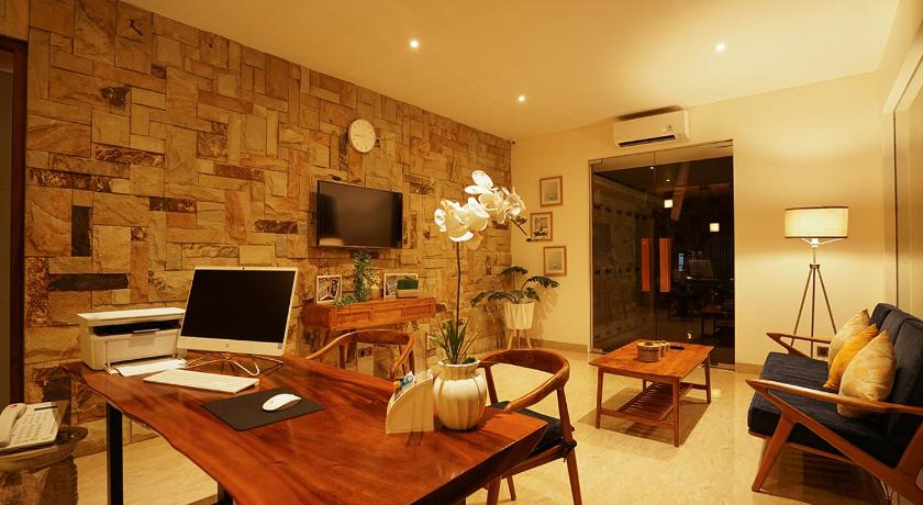 a living room filled with furniture and a laptop computer, The Mavila Sanur in Bali