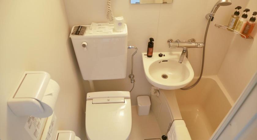 a white toilet sitting next to a sink in a bathroom, TOKYO CITY VIEW HOTEL TABATA-STATION in Tokyo