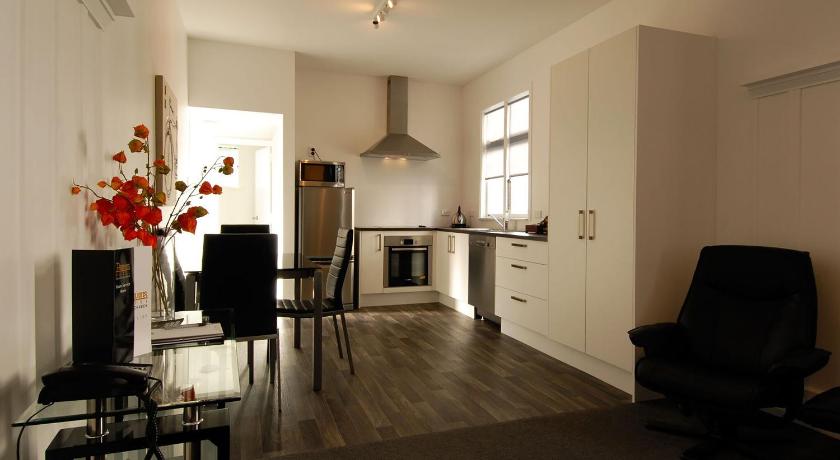 a living room filled with furniture and a large window, Pavilions Hotel in Christchurch