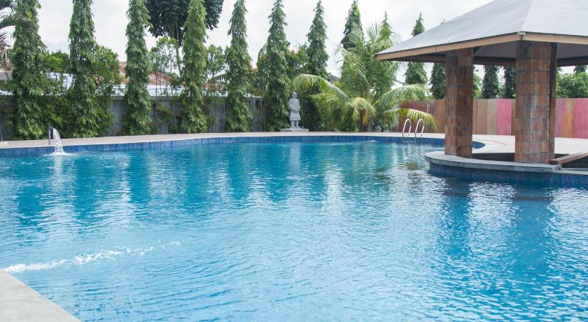 a swimming pool with a pool table and chairs, Thongs Inn Hotel Kualanamu in Medan