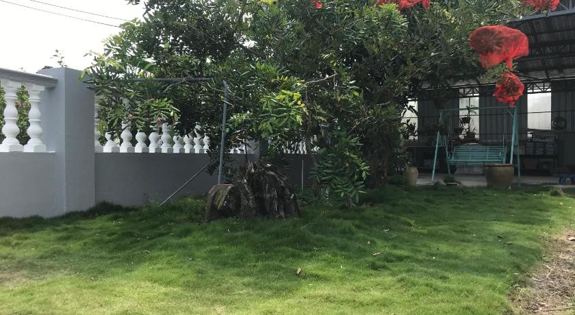 a tree filled with lots of leaves next to a fence, CoZy and comfortable Homestay in sungai siput in Ipoh