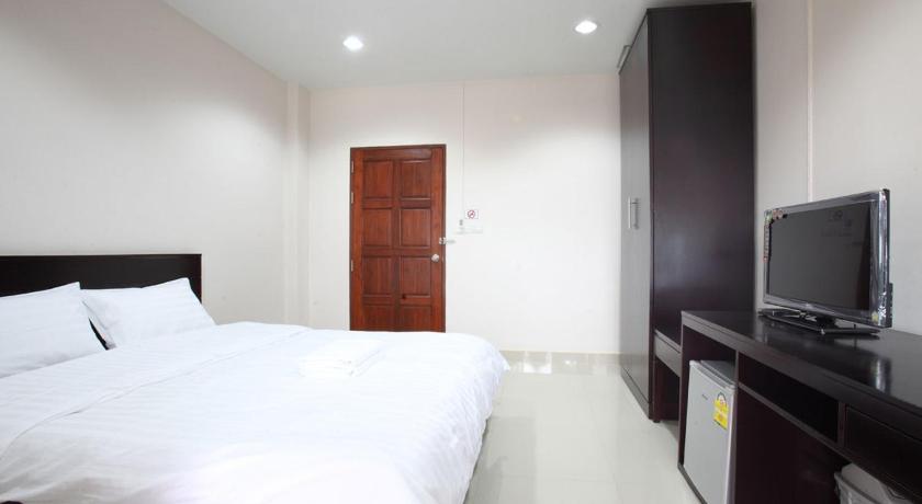 a hotel room with a bed and a television, Garden Hill Hotel in Trang