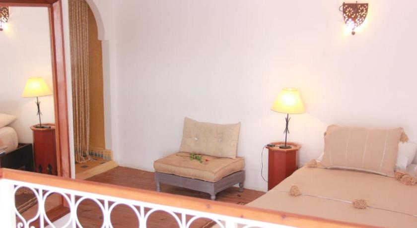 a hotel room with a large bed and a large mirror, Riad Haizea Mogador in Essaouira