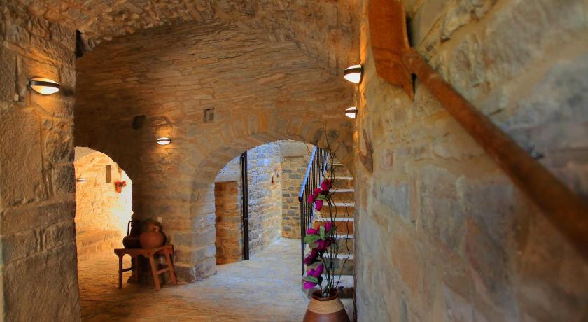 a narrow hallway leading to a small room with a stone wall, Casas Rurales Pirineo in Gerbe