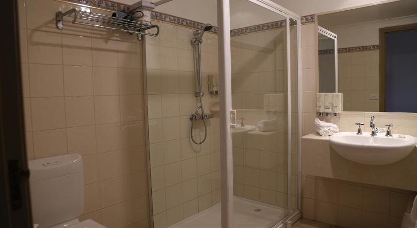 a bathroom with a shower, toilet, sink and tub, Wentworth Grande Resort in Wentworth
