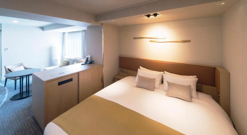 a hotel room with two beds and a large window, Hotel Granvia Osaka - JR Hotel Group in Osaka