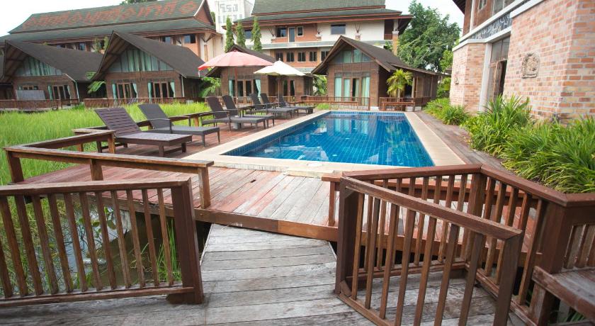 a patio area with a wooden deck and patio furniture, 100 Islands Resort and Spa in Surat Thani