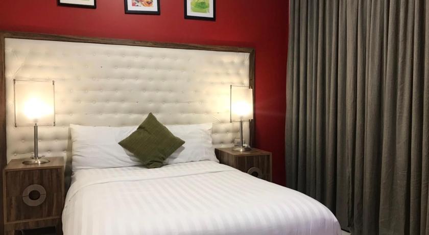 a bedroom with a large bed and a large window, Dreamwave Hotel Polangui in Legazpi