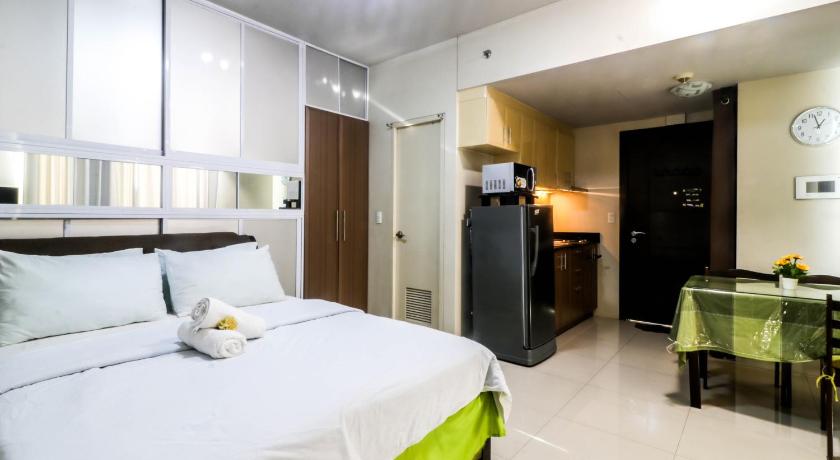 a bedroom with a large bed and a large window, Spacious and Cozy Condo Unit Across NAIA Terminal 3 in Manila