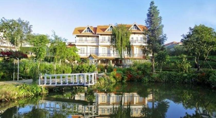 a large house with a large clock tower in front of it, Dalat Terrasse Des Roses Villa in Dalat