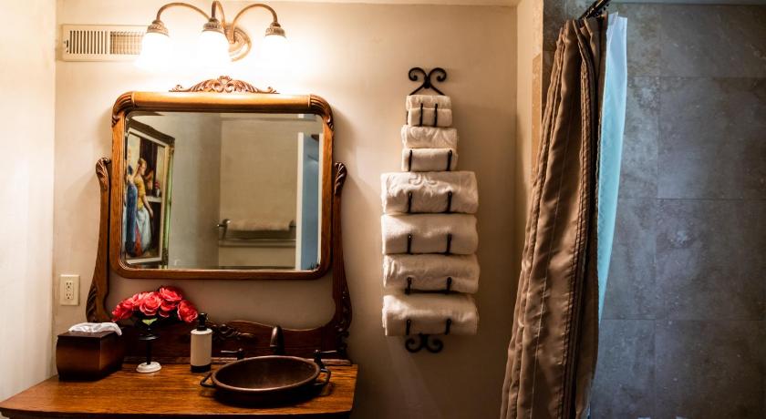a bathroom with a sink, mirror, and a towel rack, The Fillmore Inn in Twin Falls (ID)