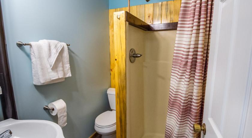 a bathroom with a shower, toilet and sink, Red Door Lodge in Homer (AK)