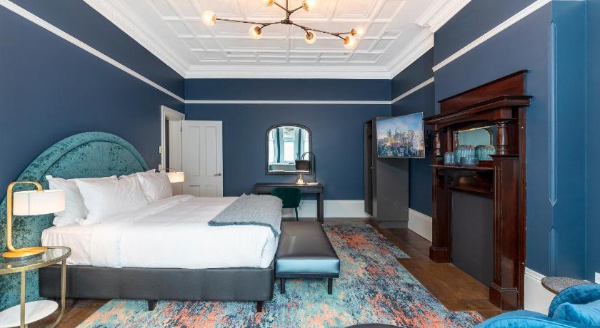 a bedroom with a bed, a chair, and a window, The Albert Mosman in Sydney