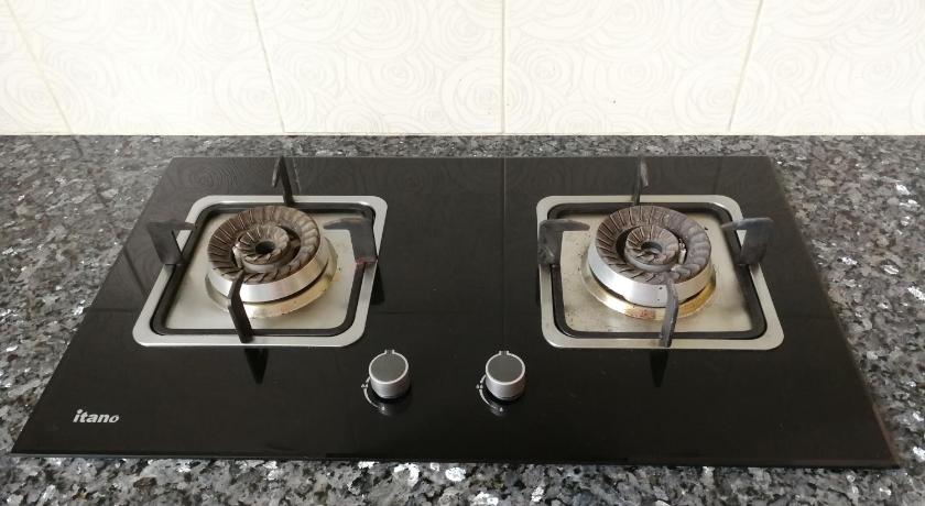a stove top oven sitting on top of a tile floor, Golden Hill in Cameron Highlands