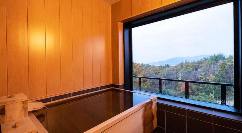 a bath tub sitting next to a window, Kajitsu no Mori in Ichinoseki