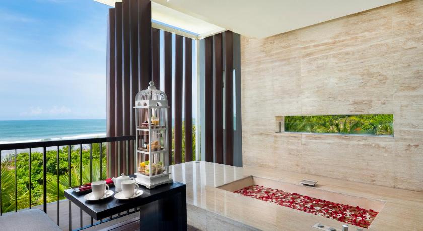 a hotel room with a balcony overlooking the ocean, Anantara Seminyak Bali Resort in Bali