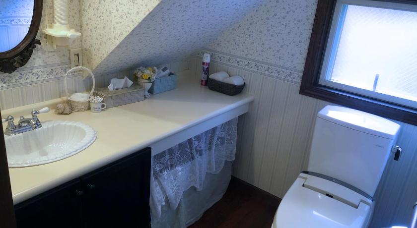 a white toilet sitting next to a sink in a bathroom, Iza Kamakura Guest House and Bar in Kamakura
