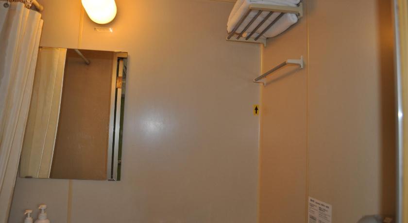 a bathroom with a sink, toilet and mirror, Green Hotel Rich Tokugawaen in Okazaki