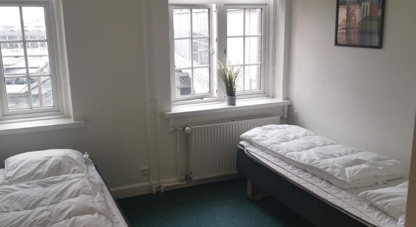 a room with a bed, a desk, and a window, Danhostel Odense City in Odense