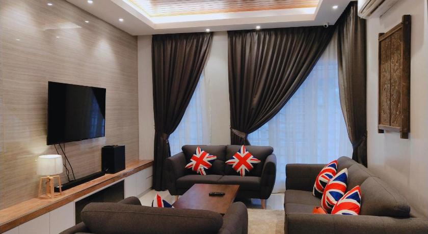 a living room filled with furniture and a tv, Sea Lion Kuala Selangor Semi-Detached Homestay in Kuala Selangor