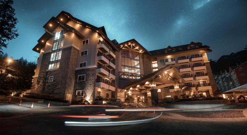 a city street at night with a large building, Azalea Hotels & Residences Baguio in Baguio
