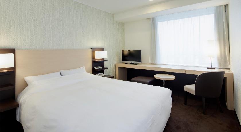 a hotel room with a large bed and a large window, Hotel Granvia Osaka - JR Hotel Group in Osaka