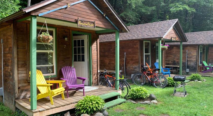 a house that has a porch and chairs in it, Pine Crest Motel & Cabins in Stowe (VT)
