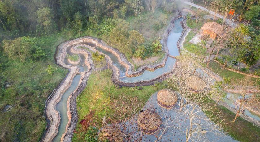 a river filled with lots of water next to a forest, Thanh Tan Hot Springs By Fusion in Hue