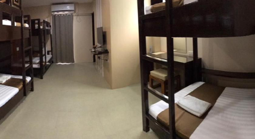 a room with two bunk beds and a large window, Hotel Juliana in Tuguegarao City