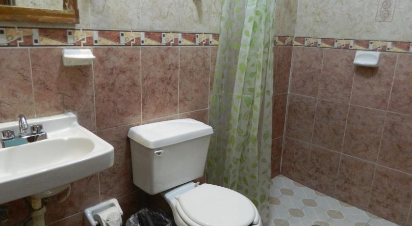 a bathroom with a toilet, sink, and tub, Emotion Tulum Hotel & Hostal in Tulum